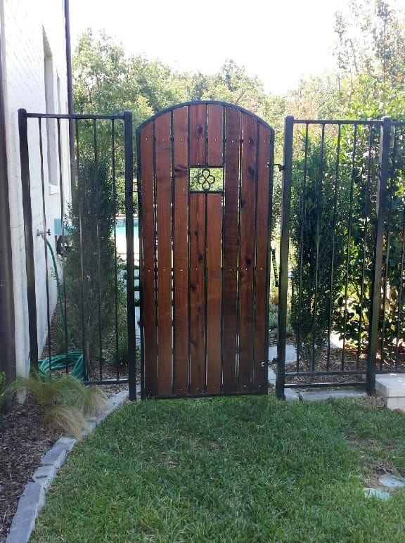 Custom iron arched gate with cedar inserts
