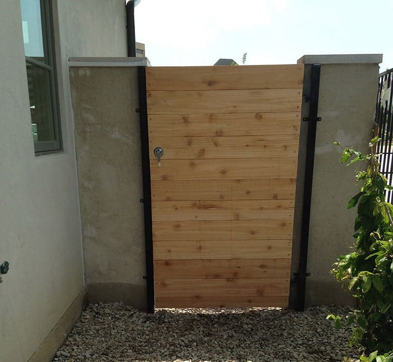 Custom iron locked gate with natural cedar finish