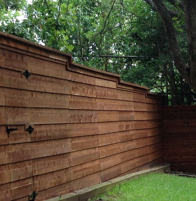 Horizontal board on board wood fence with gate