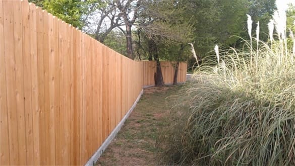 Cedar natural finish side by side fence with curb