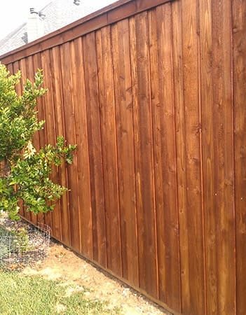 Board on board fence with pecan stain, cap, and trim