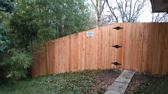 Pecan stained board on board fence with kickboard, cap, and trim