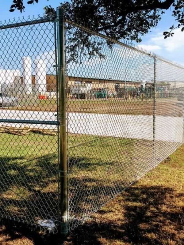 A chain-link fence installation by A and A Fence & Concrete at a Texas commercial property.
