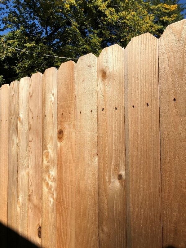 A wood fence with a natural finish.