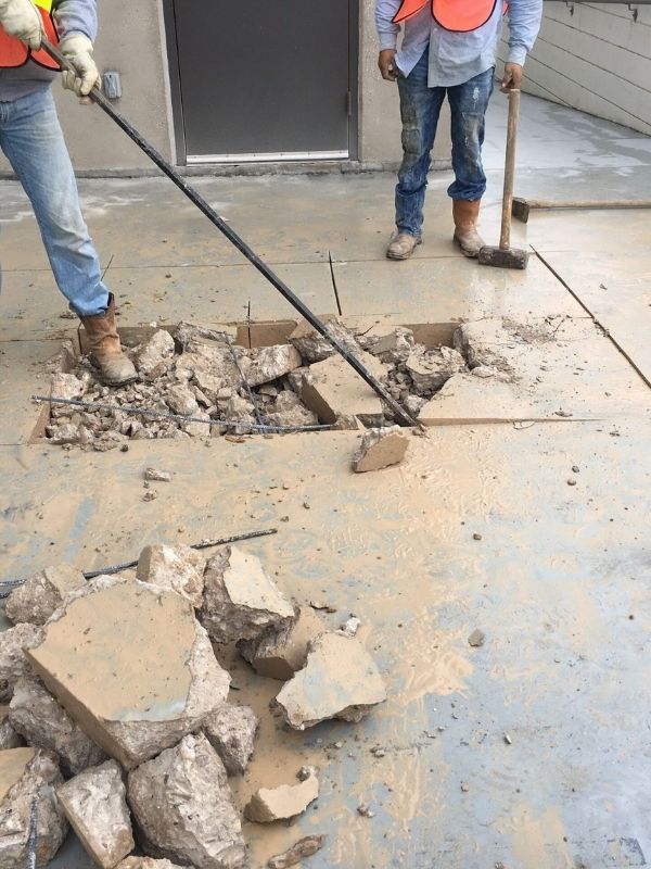 Workers replacing a section of commercial concrete.