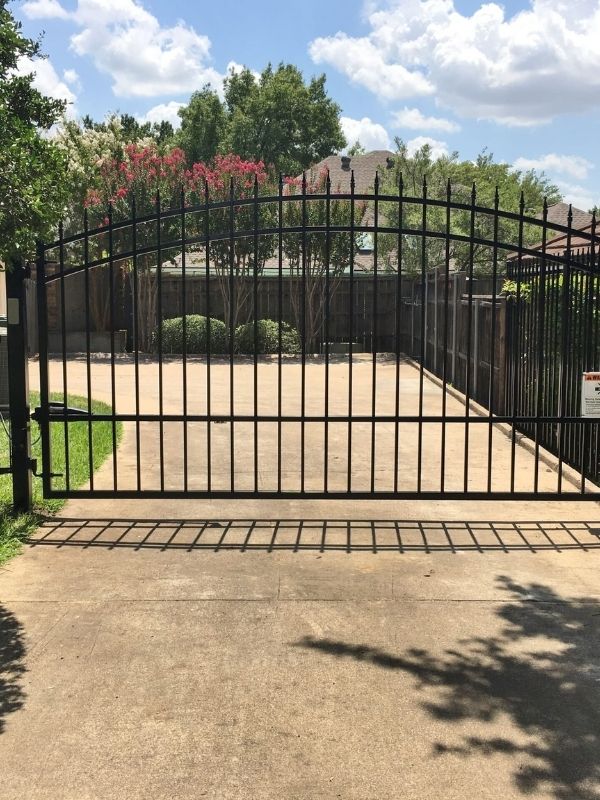 An automatic iron gate in a residential area.
