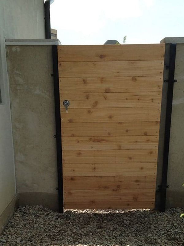 A wood walk gate with horizontal planks.