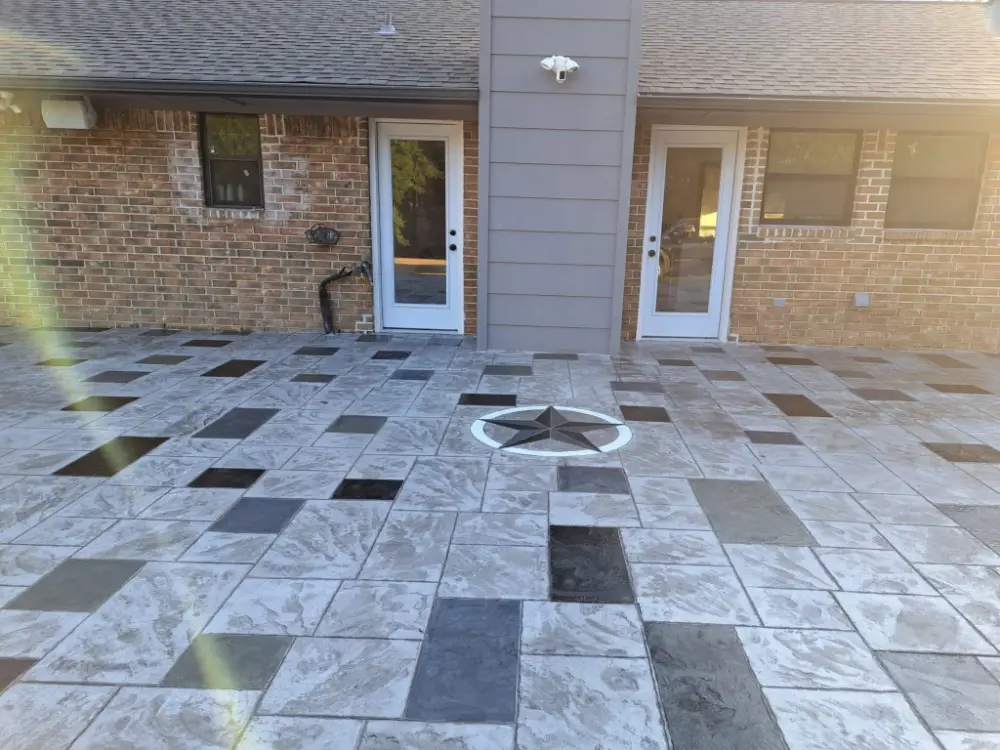 Completed patio project from A and A Fence & Concrete with decorative design