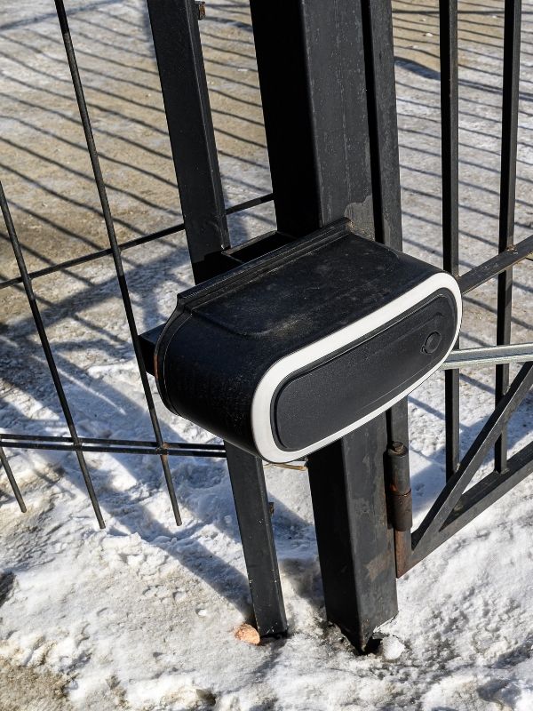 An automatic gate opener on a residential gate.