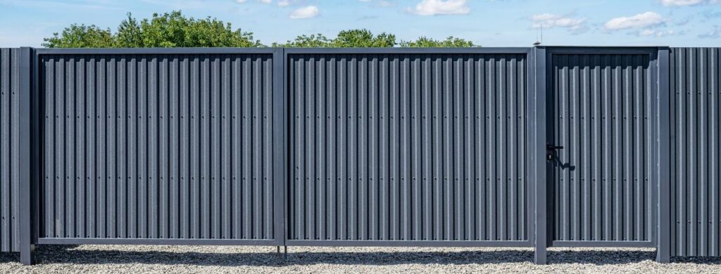 R-panel fencing on an industrial facility. 