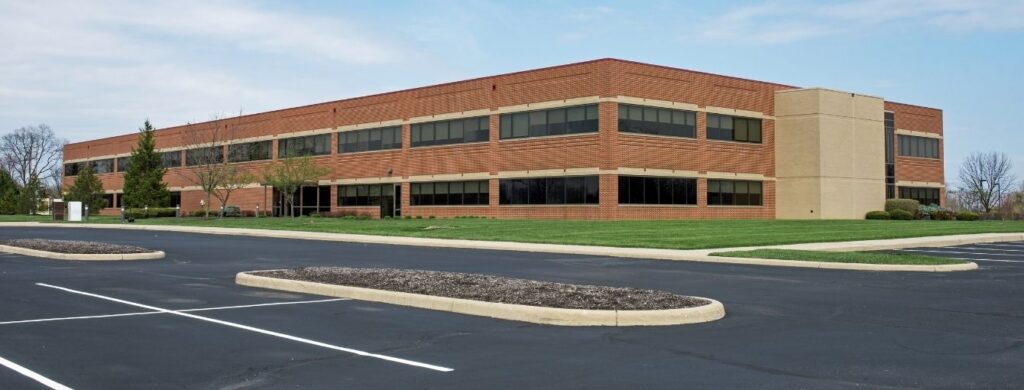 A new parking lot in front of an office building. 