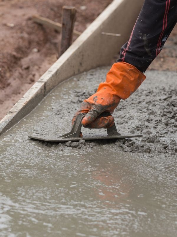 Concrete being smoothed before it dries. 