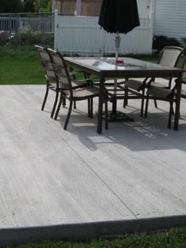 A concrete patio with a table on it. 