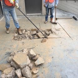 Workers Repair Commercial Sidewalk at Demilec Inc. in Arlington, TX