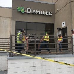 Workers Repair Commercial Sidewalk with Industrial Machinery at Demilec Inc. in Arlington, TX - Front View