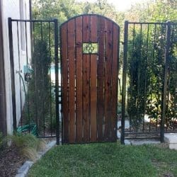 Custom iron arched gate with cedar inserts