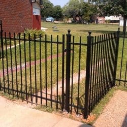 Picket-top iron fence with double swing drive gate