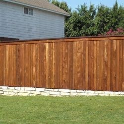 Pecan stained side by side wood fence with cap and trim