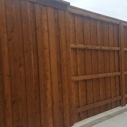 Stained Wooden Fence on Concrete