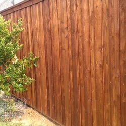 Board on board fence with pecan stain, cap, and trim